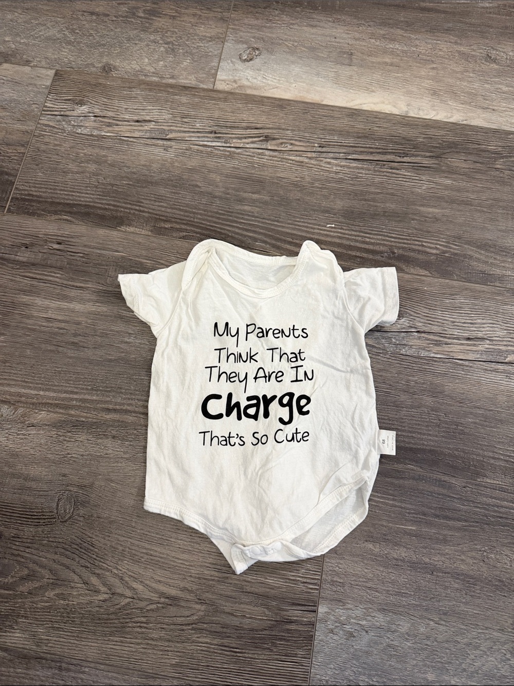 White Baby One-Piece Bodysuit with 'In Charge' Slogan